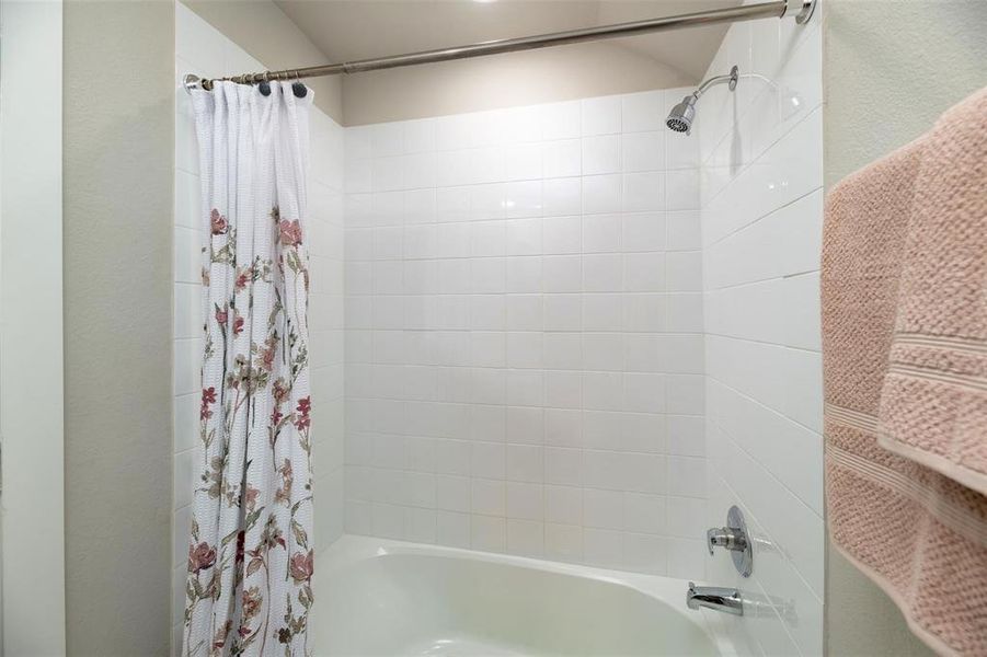 Full bathroom featuring shower / bathtub combination with curtain Full bathroom featuring shower / bathtub combination with curtain