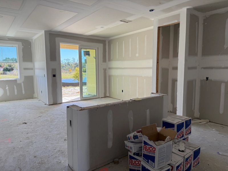 Foyer transitions into open kitchen and living space