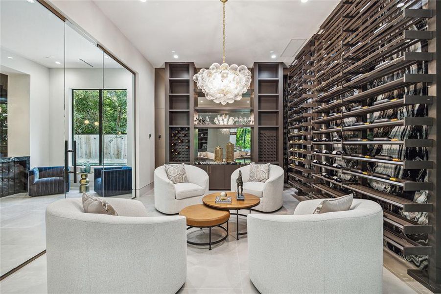 In this wine cellar, where the glow of an Avenue Lighting sets the tone for luxury and indulgence, the ambiance is further heightened by the juxtaposition of Harlem Caliza Porcelain Floor Tile and the striking Zebra Quartzite countertops and wall treatment, creating a space where every sip becomes an experience of refined taste and elegance.