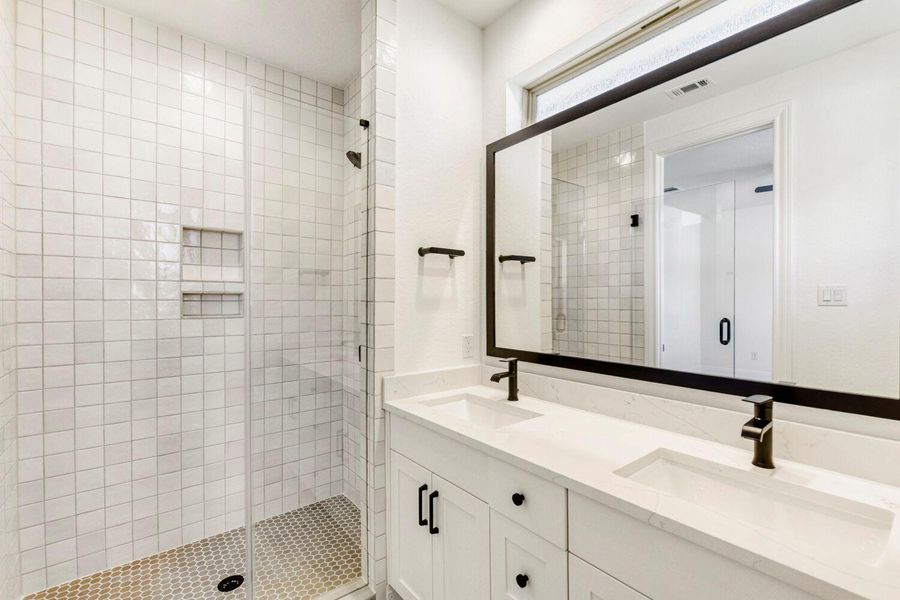Bathroom with double vanity and a stall shower Bathroom with double vanity and a stall shower