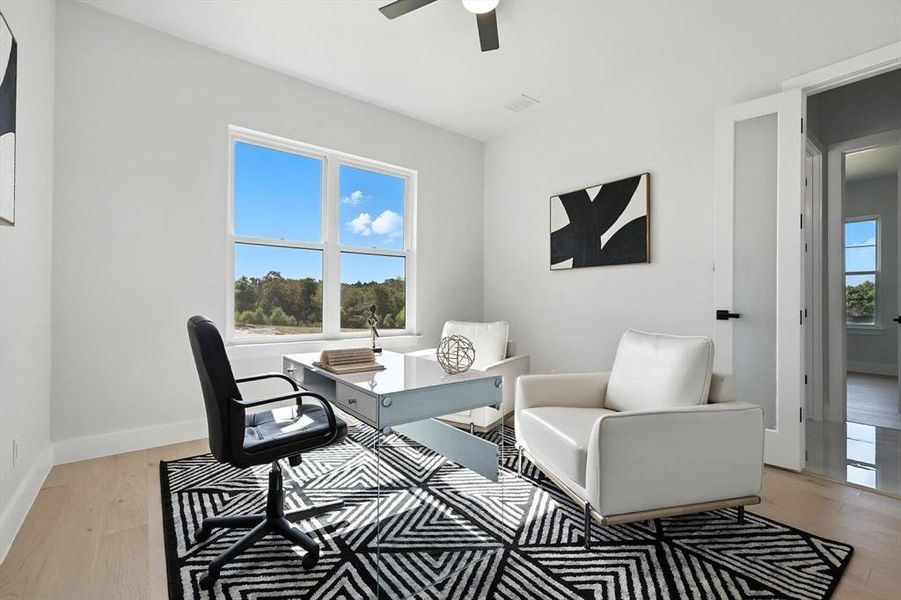 Office space featuring light wood finished floors and a ceiling fan Office space featuring light wood finished floors and a ceiling fan