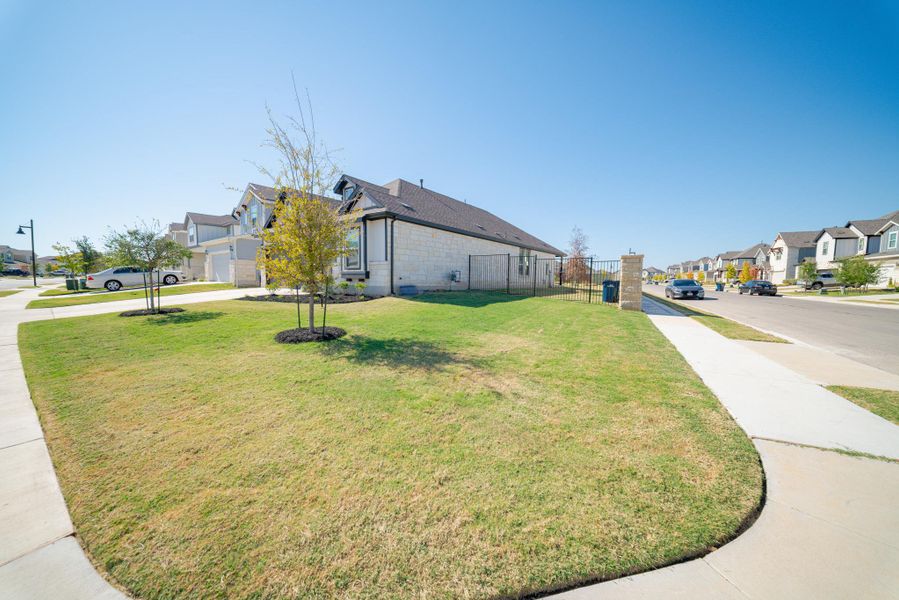 View of property exterior featuring brick siding and a residential view View of property exterior featuring brick siding and a residential view