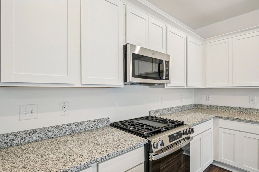 Kitchen - Chic white finishes and smooth surfaces shine.
