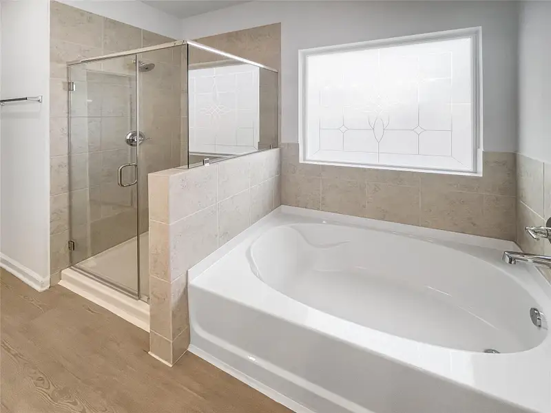 The Waring III- Primary Bathroom with Dual Vanities, Separate Garden tub and Walk-in Shower. Sample image for illustration; upgrades, options, and colors may vary. The Waring III- Primary Bathroom with Dual Vanities, Separate Garden tub and Walk-in Shower. Sample image for illustration; upgrades, options, and colors may vary.