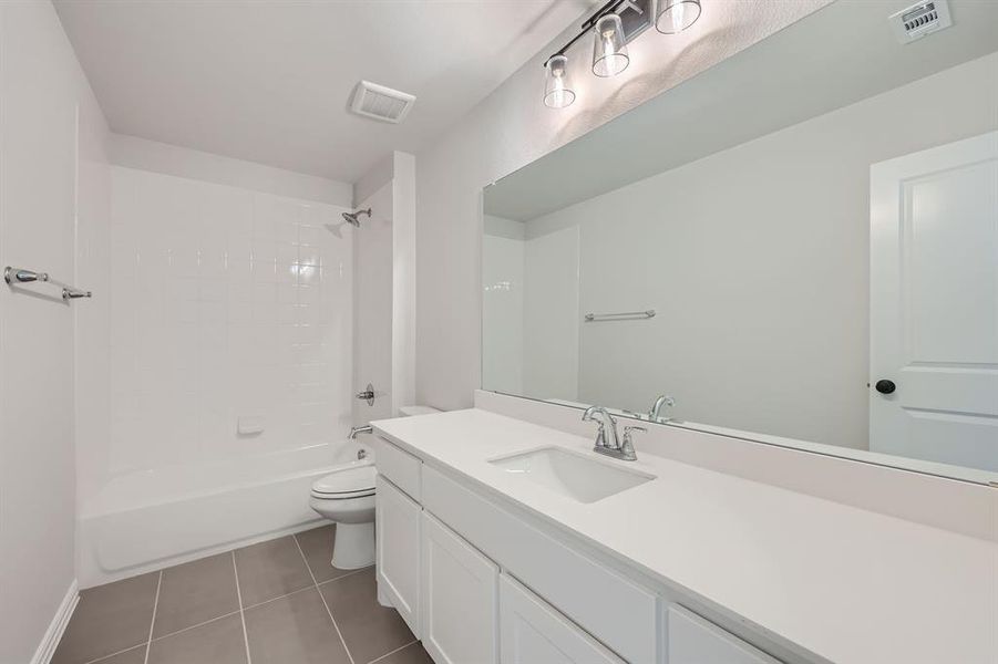 Full bathroom with vanity, shower / bathing tub combination, toilet, and tile patterned flooring