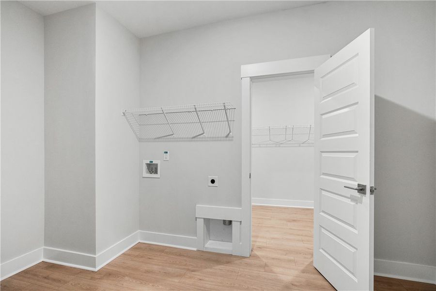 A well-appointed laundry room with convenient shel A well-appointed laundry room with convenient shel