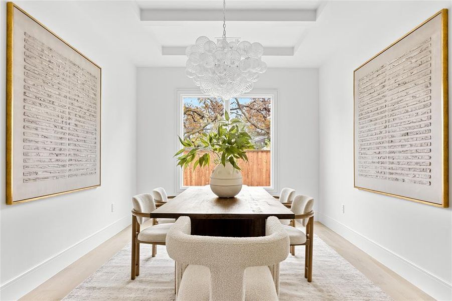 Dining space featuring a chandelier and light wood-type flooring