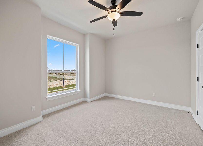 Spare room with a wealth of natural light, a ceiling fan, and light carpet Spare room with a wealth of natural light, a ceiling fan, and light carpet