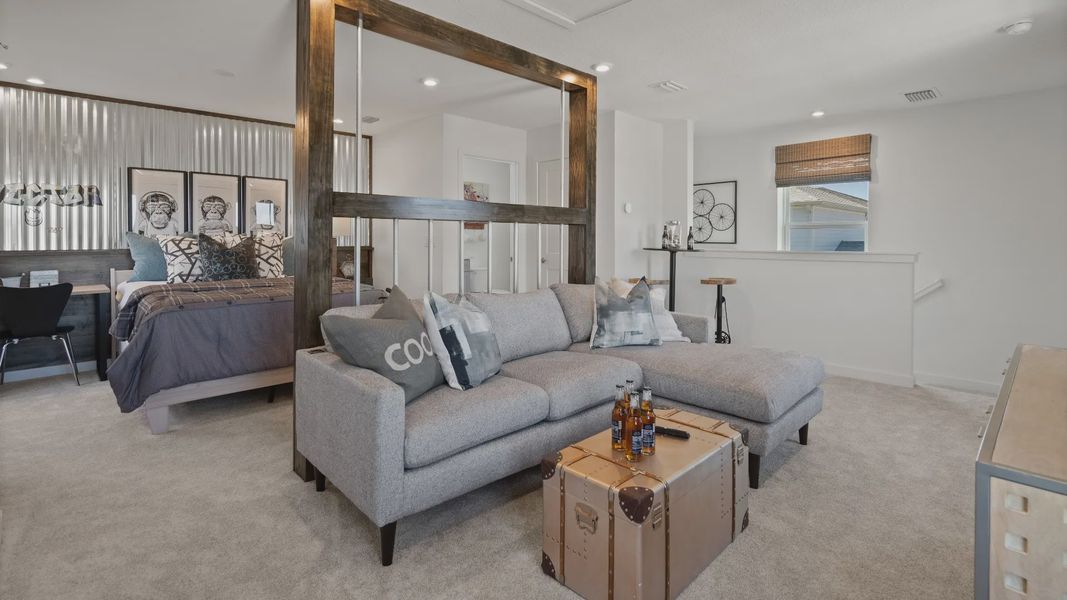 Above garage retreat space used as a family room and bedroom in a DRB Homes Ambersweet model at the Trinity Place community. Above garage retreat space used as a family room and bedroom in a DRB Homes Ambersweet model at the Trinity Place community.