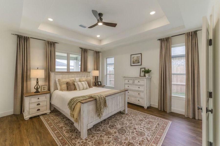 Beautifully staged for buyers. This master is fabulous with double trey ceiling and recessed lighting. A ceiling fan finishes the look.