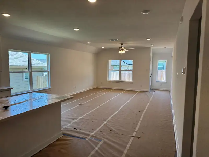 Unfurnished living room with ceiling fan, recessed lighting, and lofted ceiling Unfurnished living room with ceiling fan, recessed lighting, and lofted ceiling