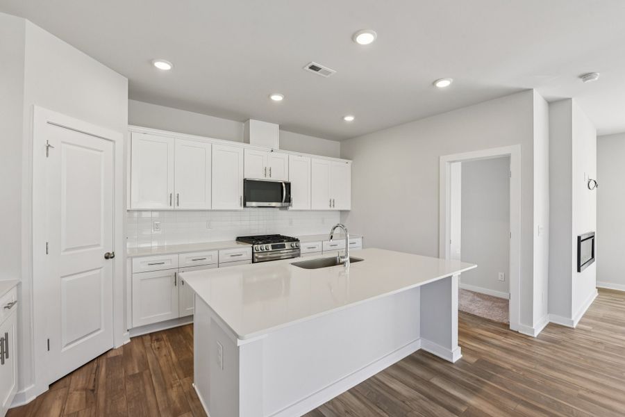 A kitchen with white cabinets.