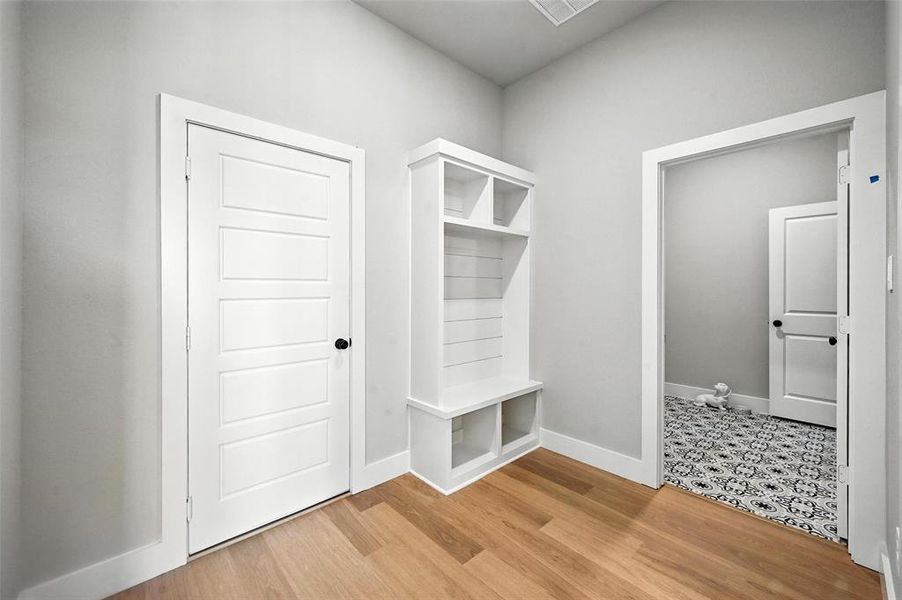 Mudroom featuring baseboards and light wood finished floors