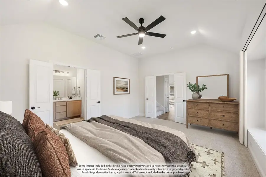Spacious master bedroom with ceiling fan, ensuite bathroom, wood dresser, and neutral carpet flooring.