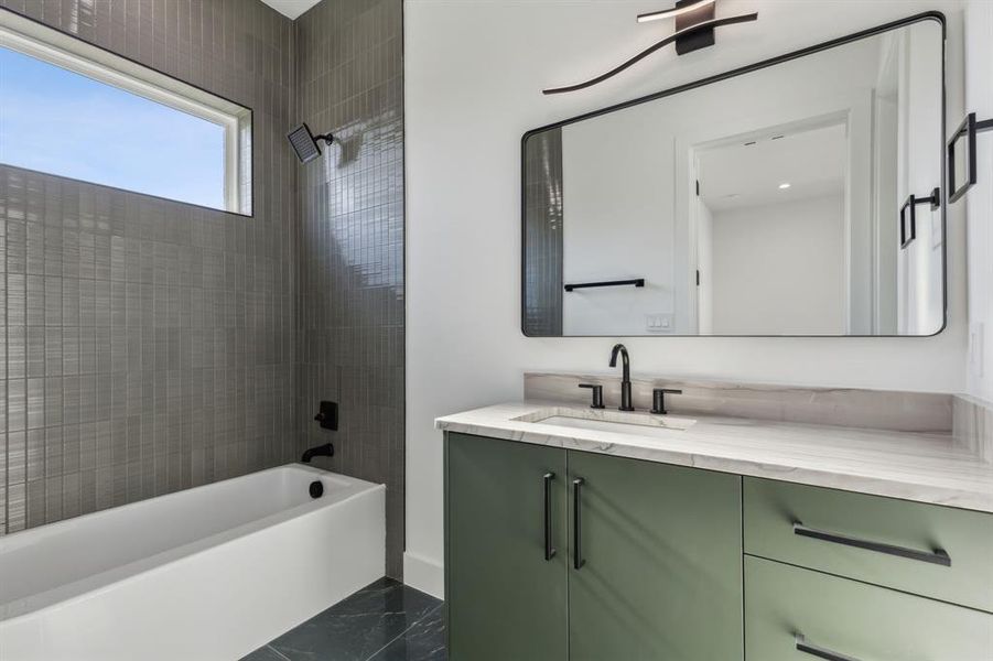 Bathroom with vanity and tiled shower / bath