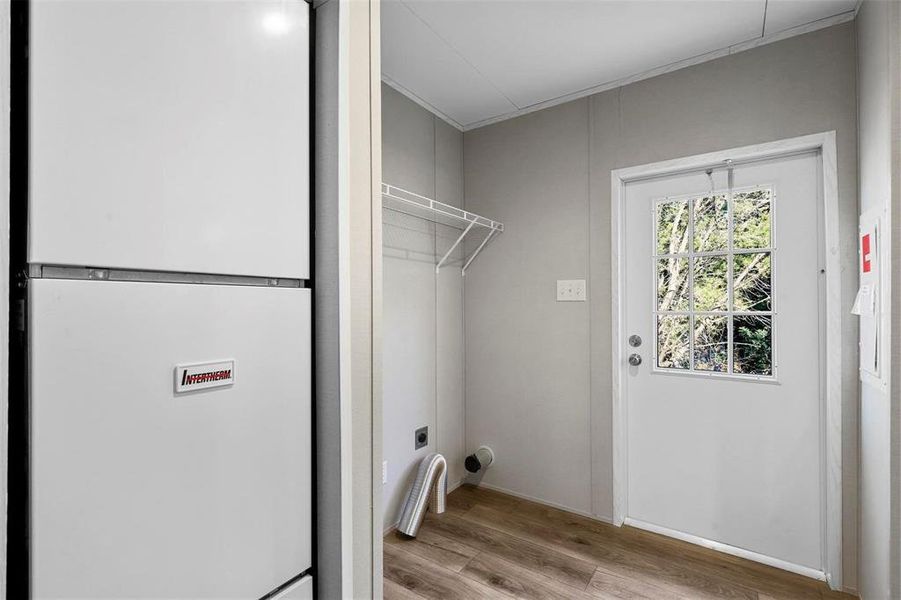 Washroom featuring wood finished floors and laundry area