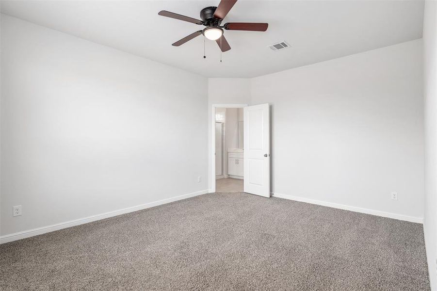 Empty room featuring carpet floors and ceiling fan