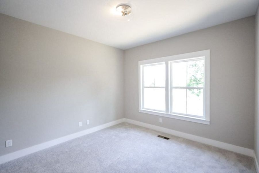 Spacious, unfurnished interior of a new home in Baker Road, Birchwood (Image 71).