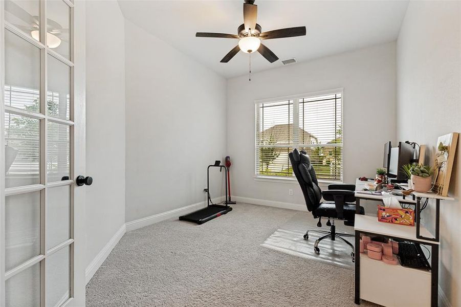 Room with light gray carpeting, neutral wall paint, and white trim