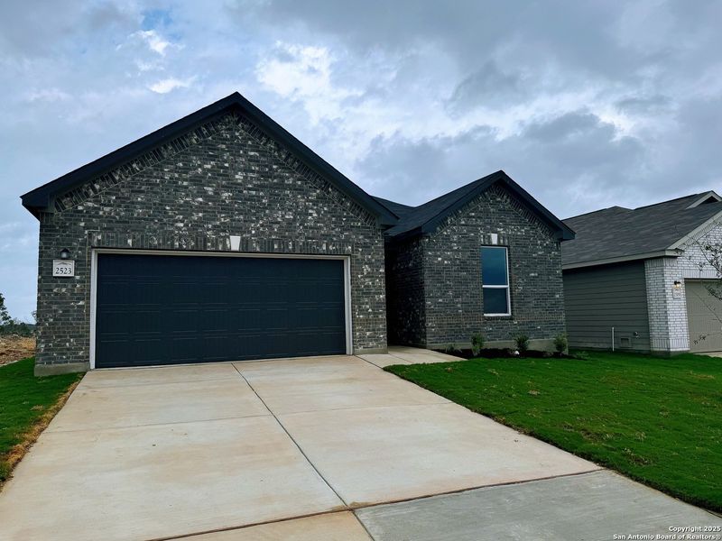 Front exterior of a new home in Hidden Bluffs at TRP, San Antonio, TX, highlighting curb appeal (Image 2). Front exterior of a new home in Hidden Bluffs at TRP, San Antonio, TX, highlighting curb appeal (Image 2).