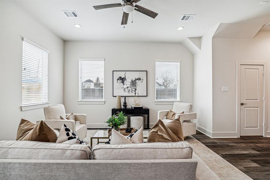 From this view of the living room, you can see the powder bath door to the right. Across the hall of the powder bath is the entry to the two-car garage.