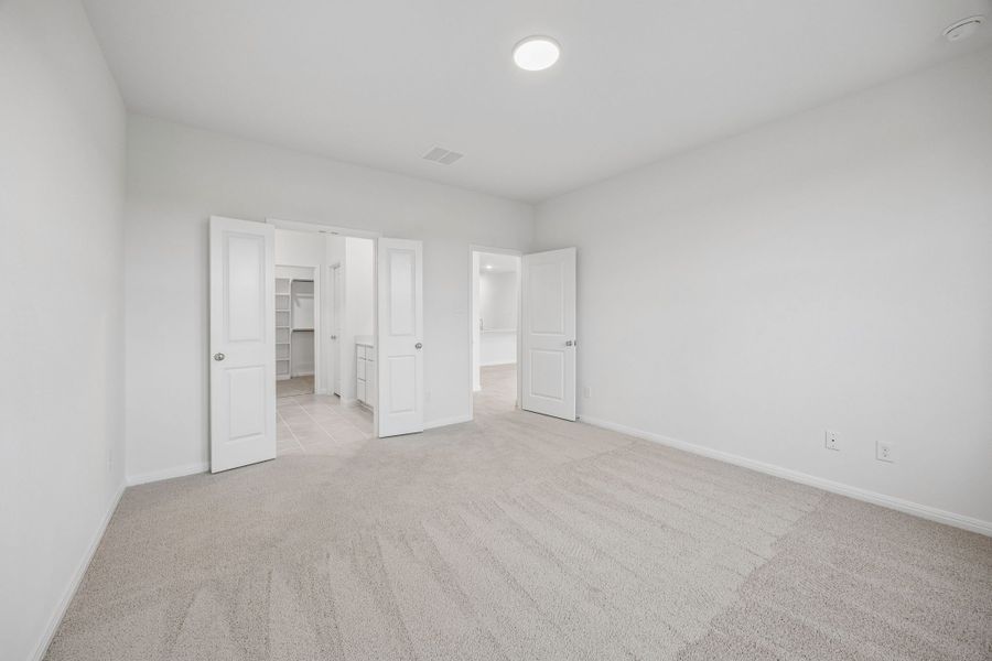 Primary Bedroom in the Magnolia home plan by Trophy Signature Homes – REPRESENTATIVE PHOTO