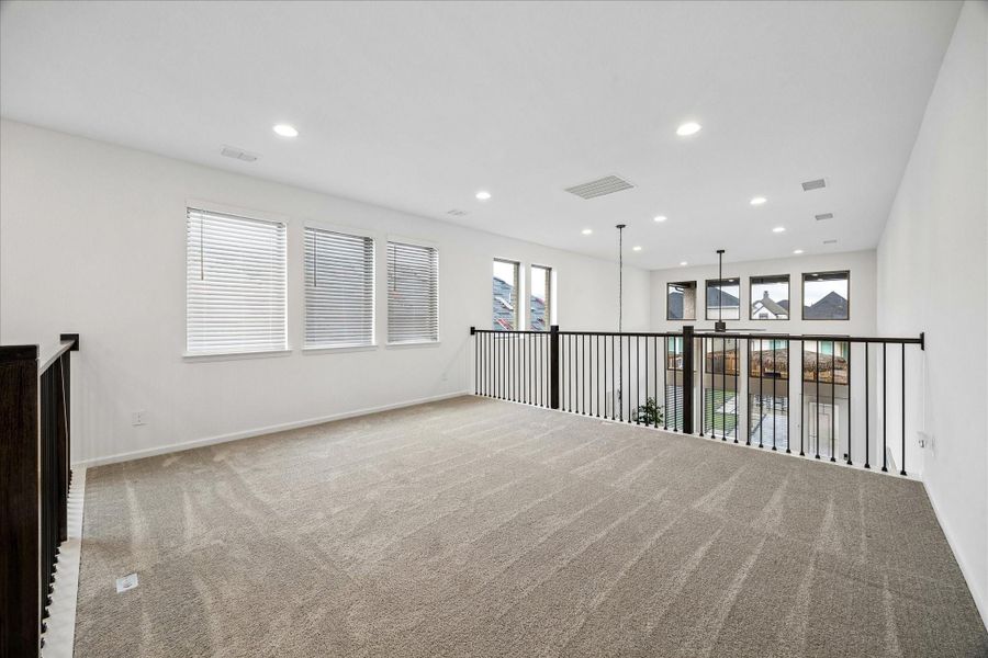It’s all fun and games in this super-sized game room with plenty of space for your favorite setup, from movie nights and game tables to a cozy hangout zone. Open railings overlook the family room on one side and the foyer on the other, adding to the home’s bright, airy feel.
