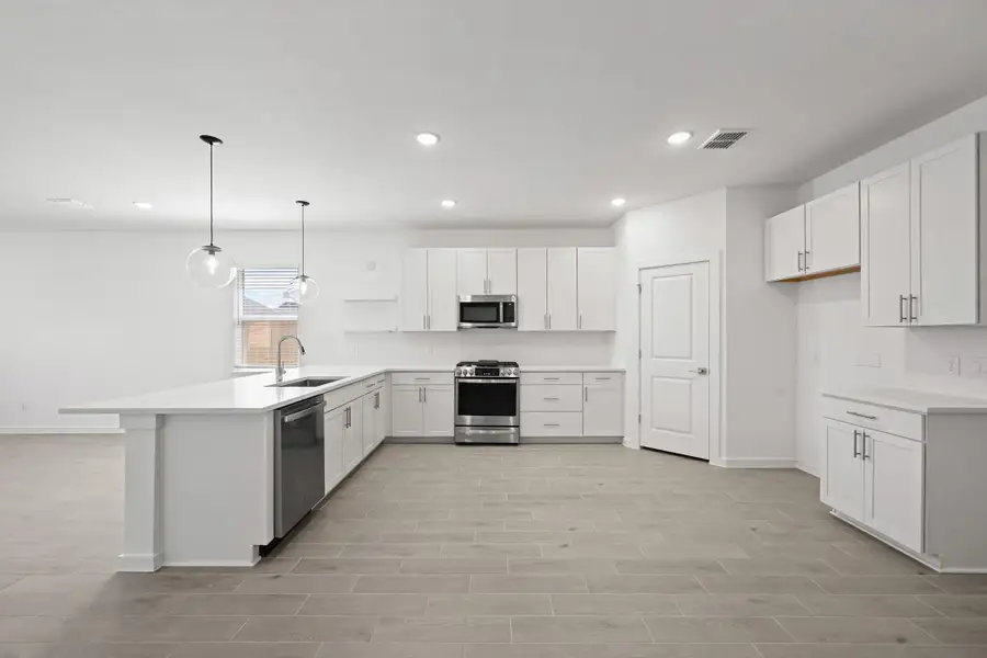 Gorgeous kitchen with white cabinets and quartz counters (*Artist rendering used for illustration purposes only.)
