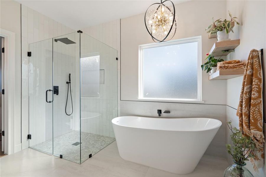 Bathroom with independent shower and bath and a chandelier