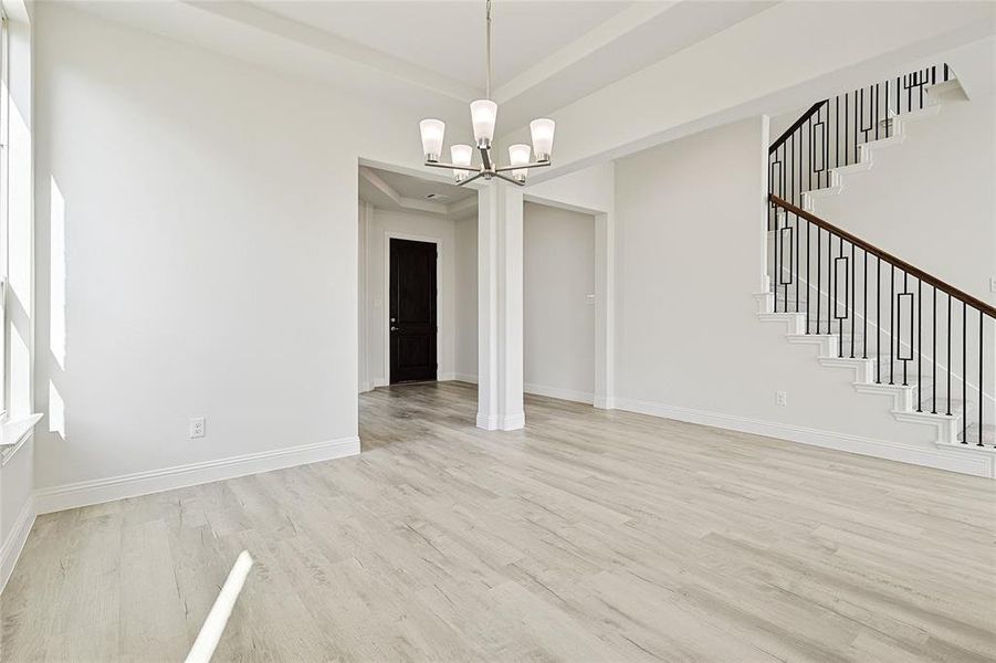 Unfurnished dining area with light hardwood / wood-style flooring and an inviting chandelier