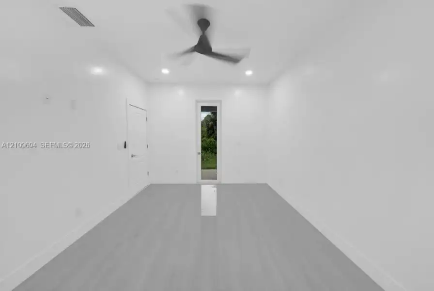 Room featuring wood-finish flooring, recessed lighting, a modern ceiling fan, and a glass-paneled exterior door