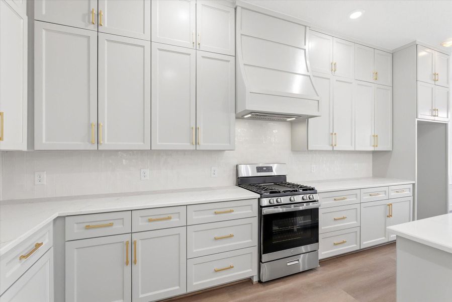 The kitchen offers exceptional storage with floor-to-ceiling soft-close cabinetry and drawers designed for both beauty and function.