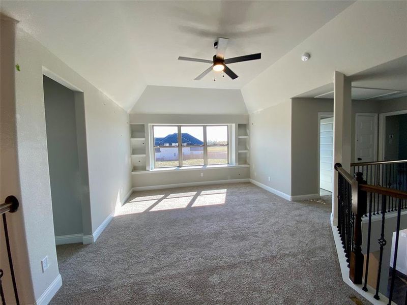 Gameroom has built-in shelves and ceiling fan