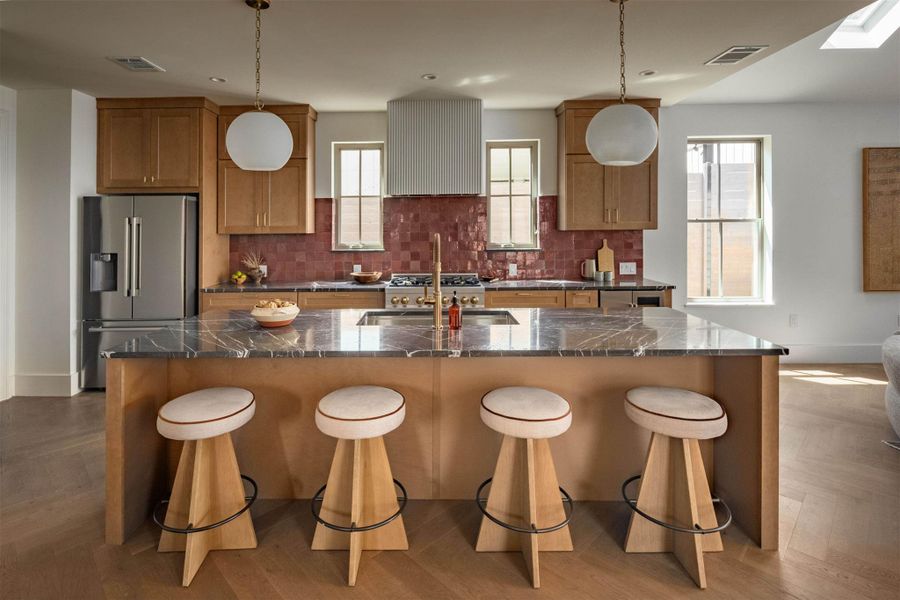 Rich wood cabinetry and a marble-topped island define this sophisticated modern kitchen space. Rich wood cabinetry and a marble-topped island define this sophisticated modern kitchen space.