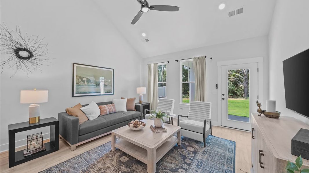 Tasteful family room with two-story volume, refined finishes, and exceptional natural light at Barton Hollow