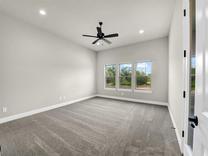 Empty room with ceiling fan and carpet