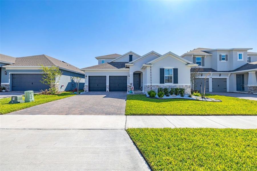 Front exterior of a new home in Hartwood Landing, Clermont, FL, highlighting curb appeal (Image 27).