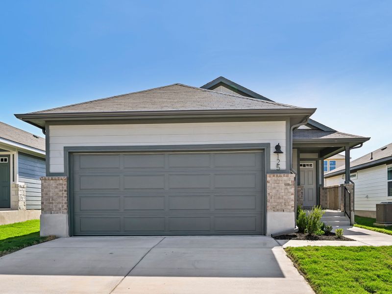 Front exterior of a new home in Travena - Americana Collection, Georgetown, TX, highlighting curb appeal (Image 1). Front exterior of a new home in Travena - Americana Collection, Georgetown, TX, highlighting curb appeal (Image 1).