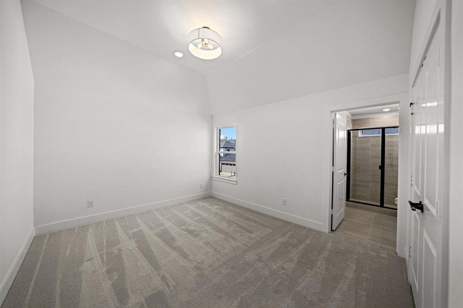 Unfurnished bedroom featuring light carpet and baseboards