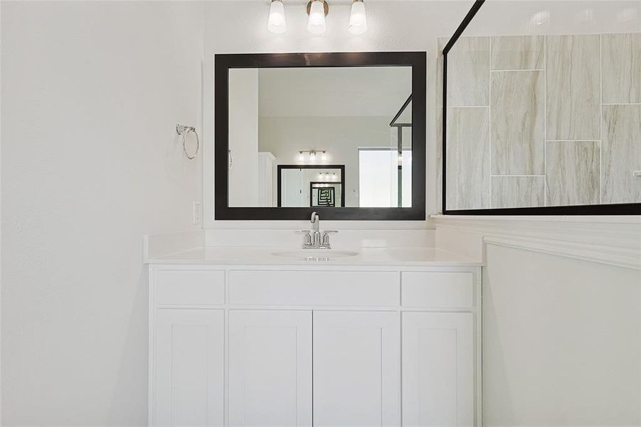 Bathroom with vanity and a shower