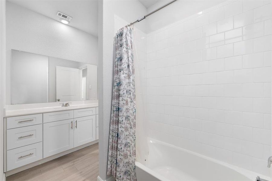 Bathroom featuring vanity and shower / bath combo