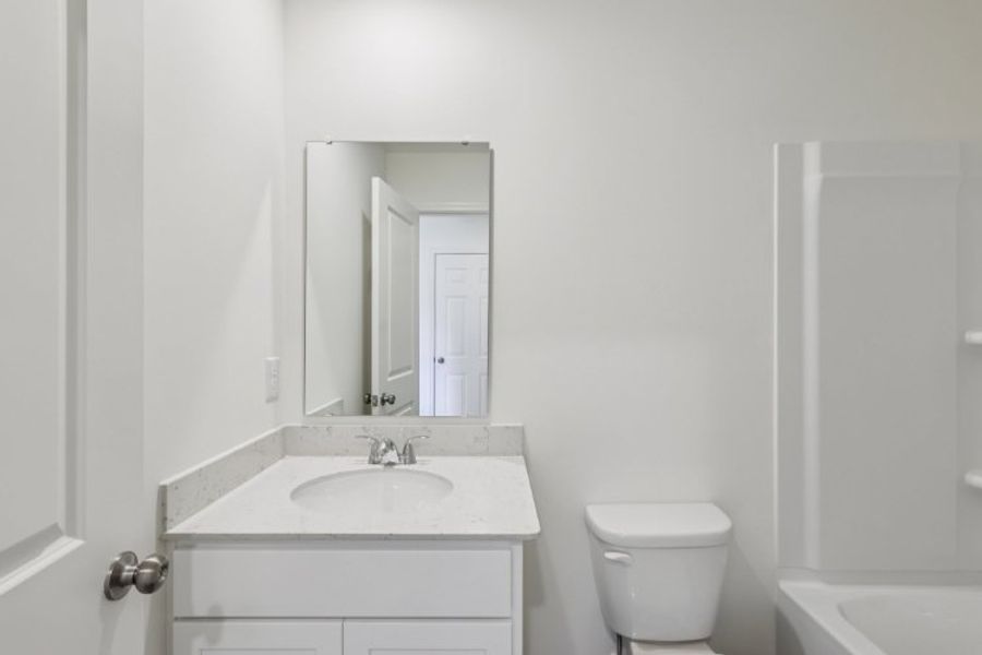 A bathroom with a sink and toilet.