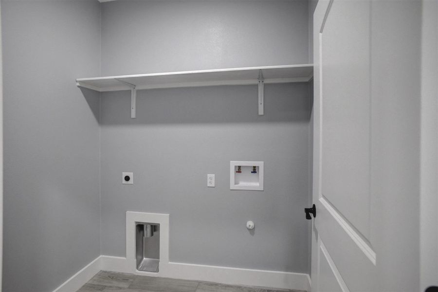 Good size utility room with water and dryer hook ups