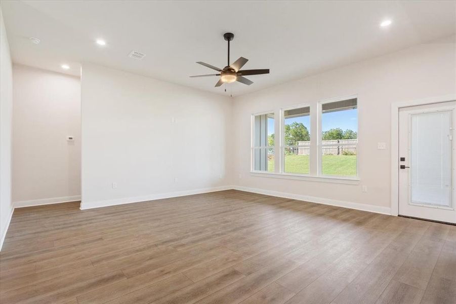 Unfurnished living room featuring recessed lighting, light wood finished floors, and ceiling fan Unfurnished living room featuring recessed lighting, light wood finished floors, and ceiling fan