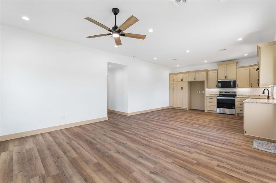 Unfurnished living room featuring recessed lighting, light wood-type flooring, and a ceiling fan