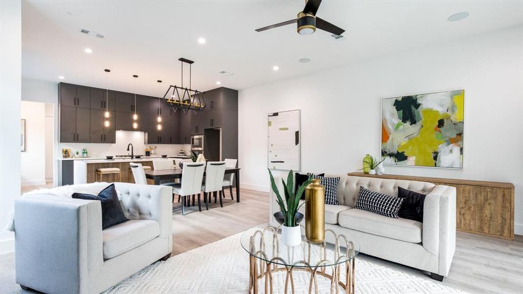 Living room with ceiling fan, sink, and light hardwood / wood-style flooring