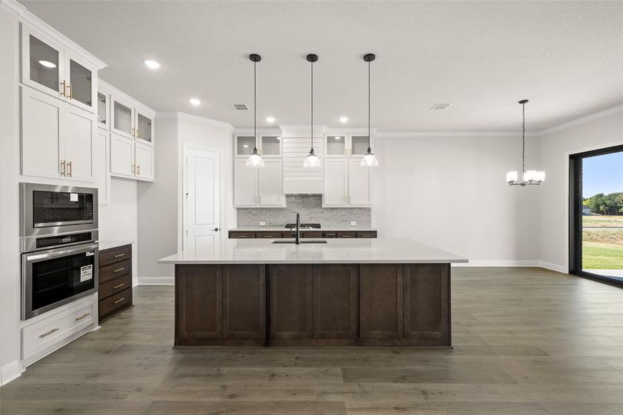 Kitchen with large island, decorative lighting, and Dining nook.