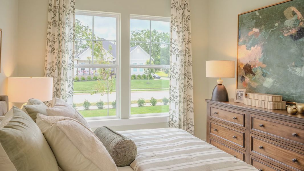 Secondary bedroom with carpet and bright natural light from windows Secondary bedroom with carpet and bright natural light from windows