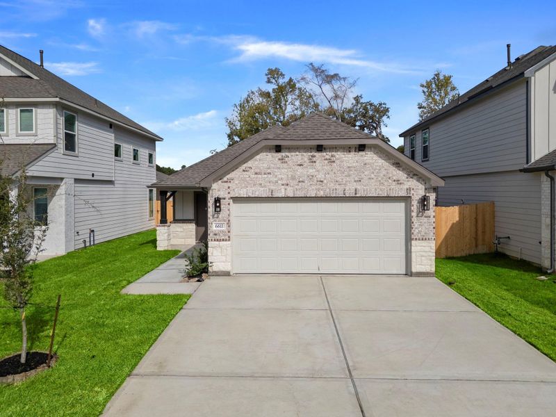 Front exterior of a new home in Cypresswood Landing, Humble, TX, highlighting curb appeal (Image 1).