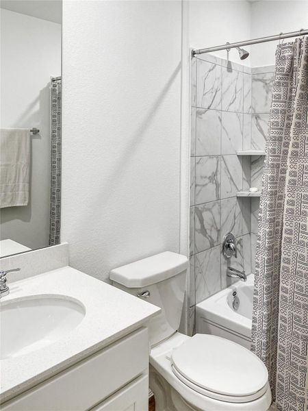 Hall bath showing the tile shower surround